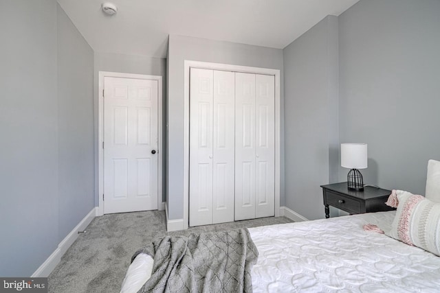 carpeted bedroom with a closet