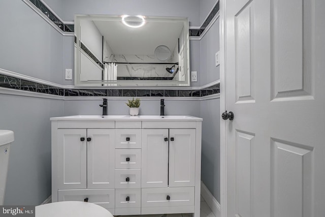 bathroom featuring vanity and toilet