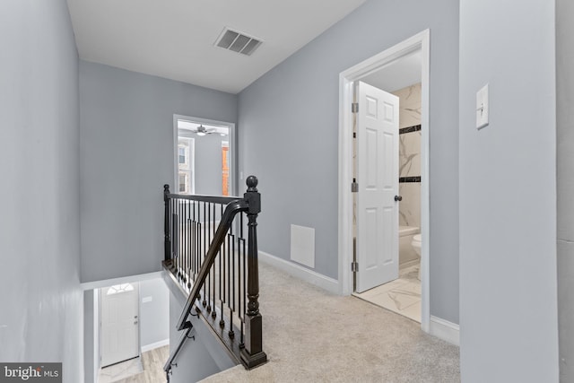 corridor with light colored carpet