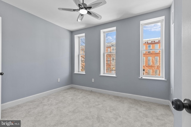 unfurnished room with ceiling fan and light colored carpet