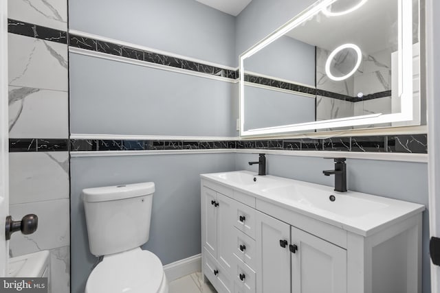 bathroom featuring vanity and toilet