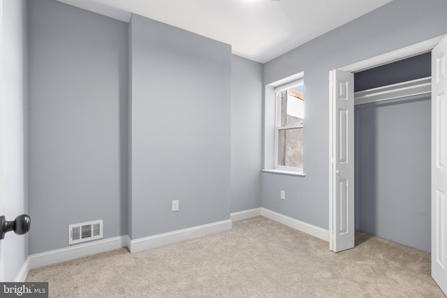 unfurnished bedroom with light colored carpet