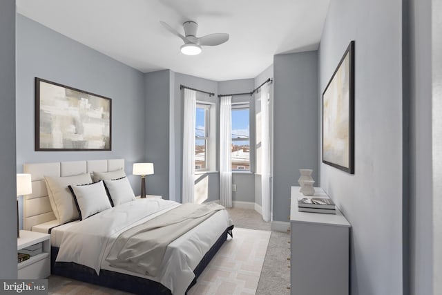 bedroom featuring light colored carpet and ceiling fan