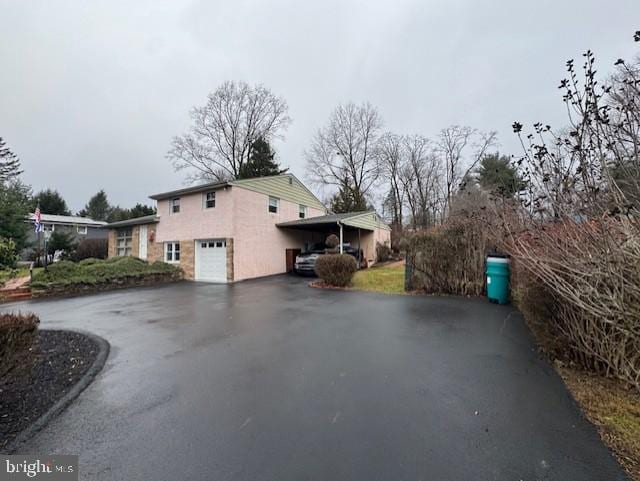 view of home's exterior featuring a garage and a carport