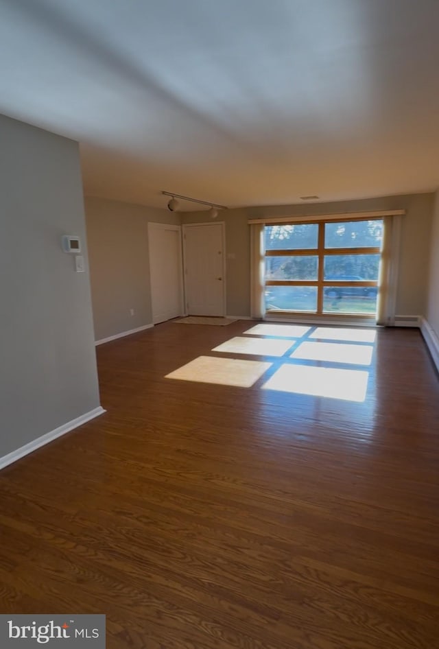 spare room featuring dark hardwood / wood-style flooring