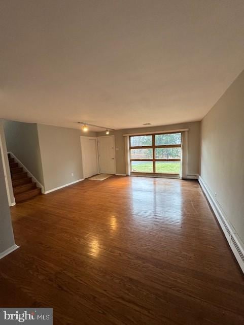 unfurnished room with dark hardwood / wood-style floors