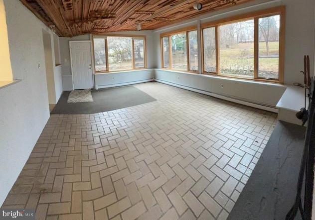 unfurnished sunroom with lofted ceiling