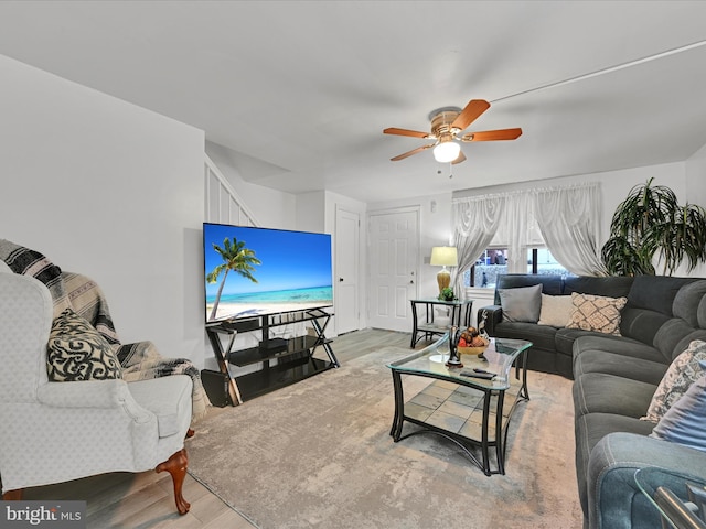 living room featuring ceiling fan and light hardwood / wood-style floors