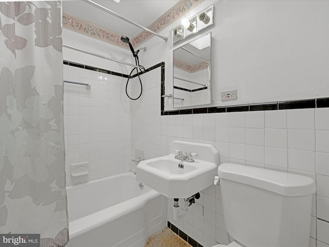 bathroom with shower / tub combo, tile walls, and toilet