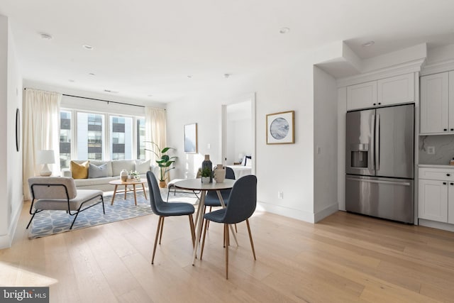 dining area featuring light wood-type flooring