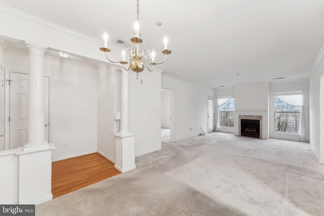 unfurnished living room with a chandelier, light hardwood / wood-style floors, and crown molding