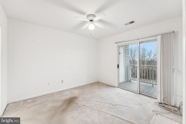 empty room with ceiling fan and light colored carpet