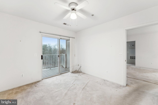 spare room featuring light carpet and ceiling fan