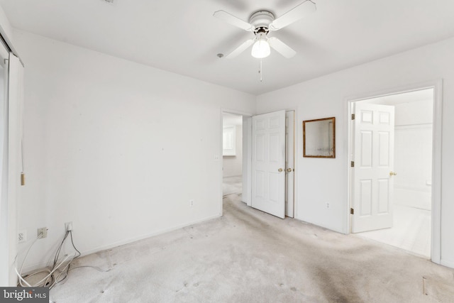 unfurnished bedroom featuring light carpet, a closet, and ceiling fan