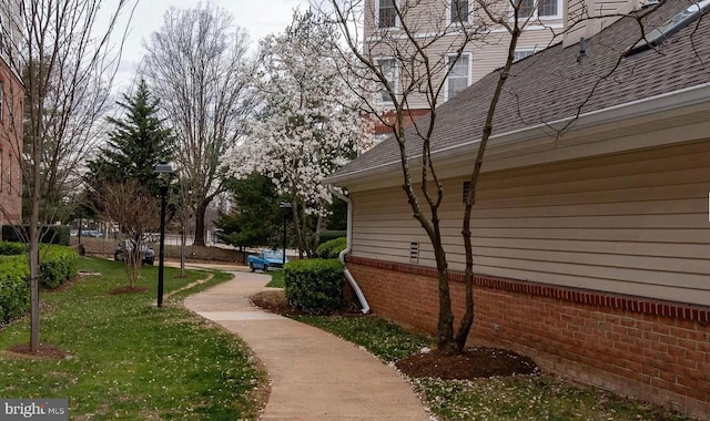 view of property exterior with a lawn