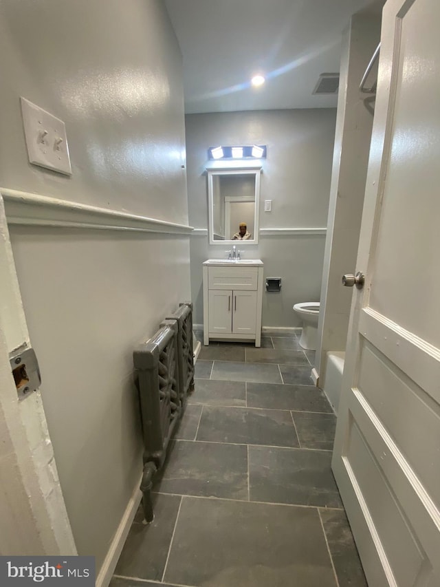 bathroom featuring vanity and toilet