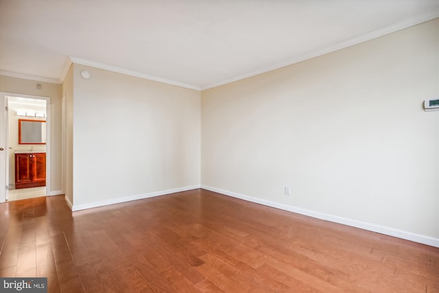 unfurnished room featuring hardwood / wood-style flooring and crown molding