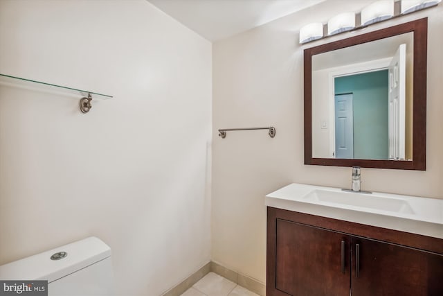 bathroom featuring tile patterned floors, vanity, and toilet