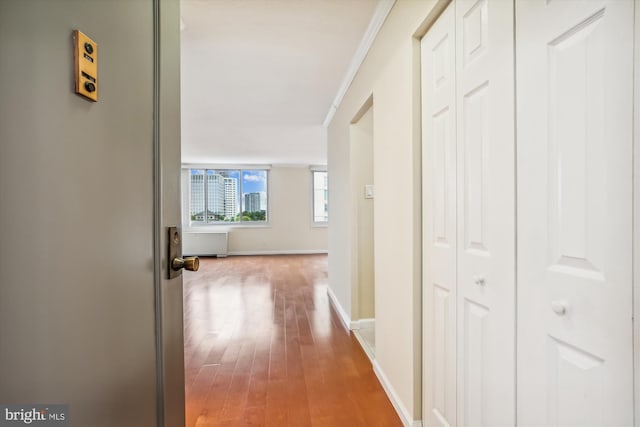 hall with crown molding and hardwood / wood-style floors