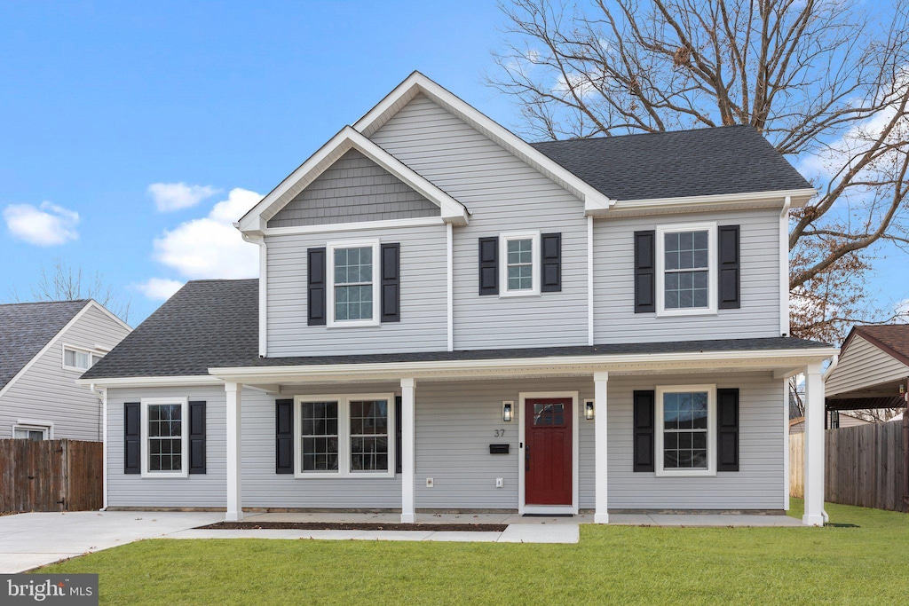 view of front of home with covered porch and a front lawn