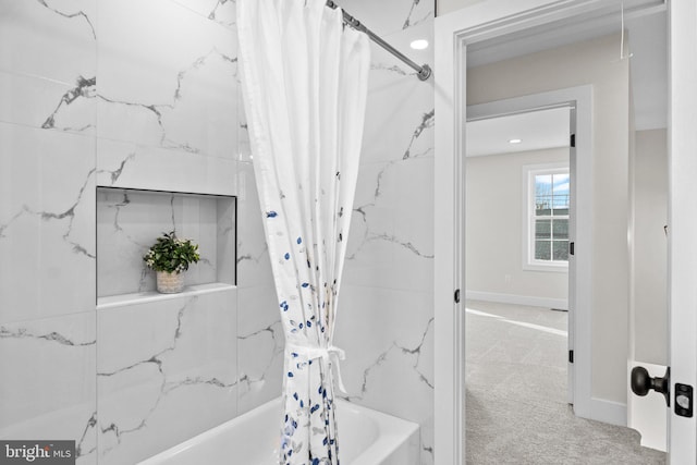 bathroom with shower / bath combination with curtain