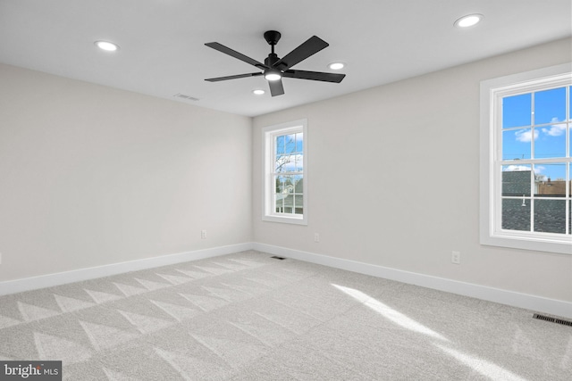 unfurnished room featuring light colored carpet and ceiling fan