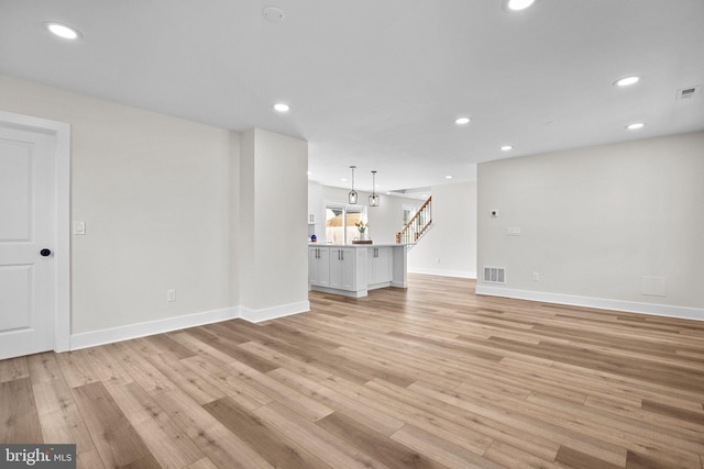 unfurnished living room with light hardwood / wood-style floors