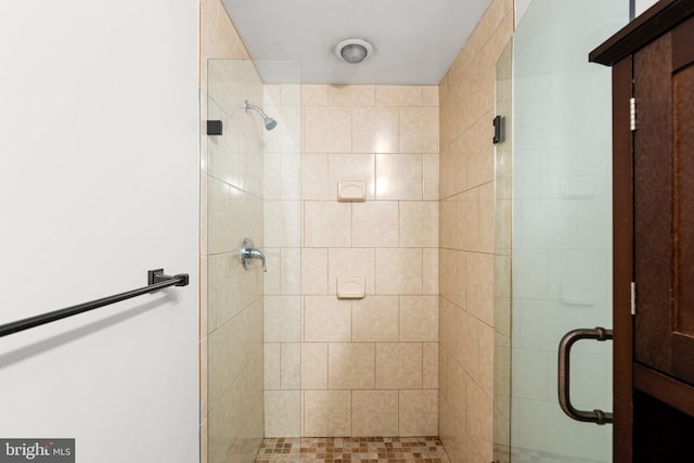 bathroom with a shower with door