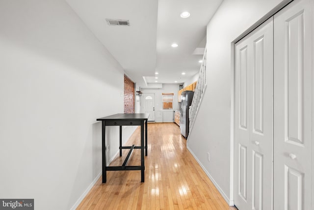 hallway with light hardwood / wood-style flooring