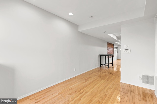 unfurnished room with light wood-type flooring