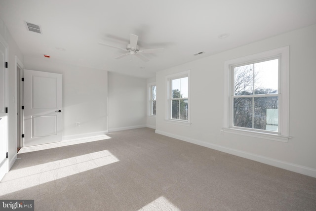 unfurnished room featuring ceiling fan and light carpet