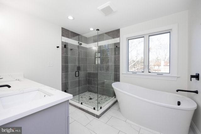 bathroom featuring vanity and separate shower and tub