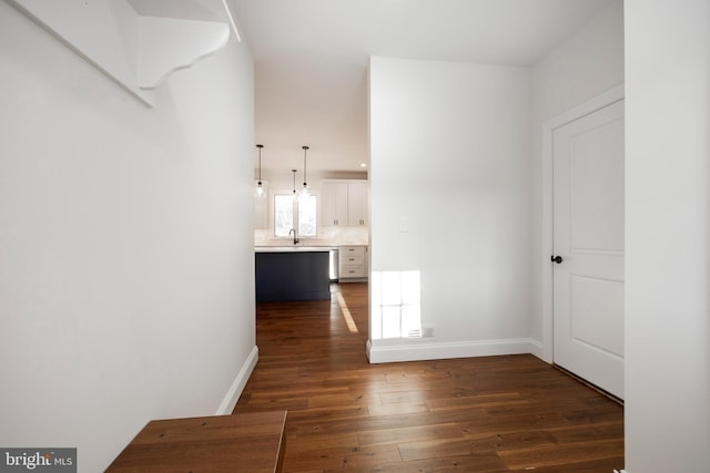 hallway with dark hardwood / wood-style flooring