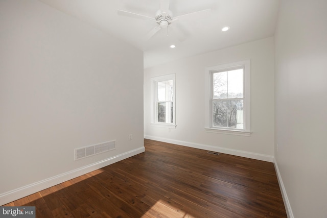 empty room featuring ceiling fan and dark hardwood / wood-style flooring