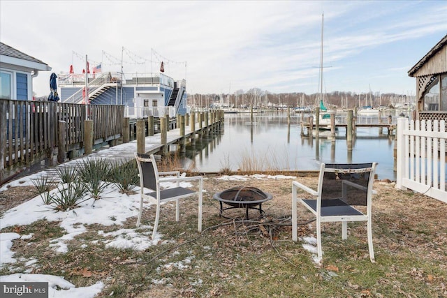 view of dock featuring a water view and a fire pit