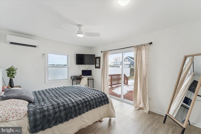 bedroom featuring access to exterior, a wall mounted air conditioner, ceiling fan, and light wood-type flooring