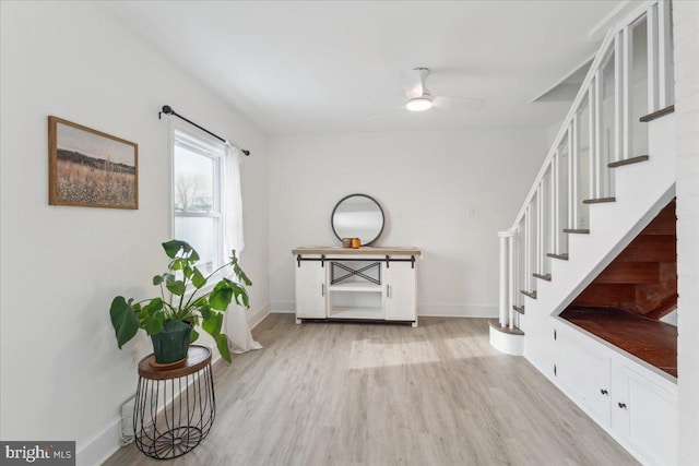 foyer featuring ceiling fan and light wood-type flooring