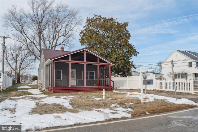 view of front of property featuring a sunroom