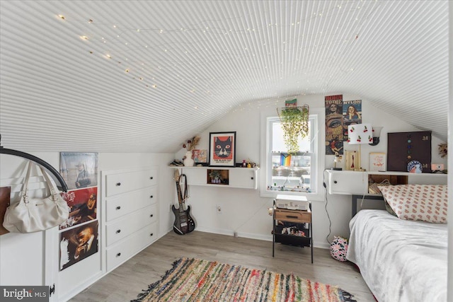 bedroom featuring lofted ceiling and light hardwood / wood-style flooring