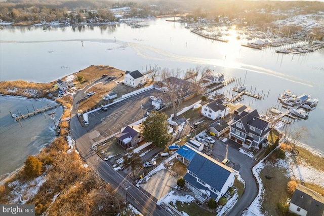 snowy aerial view with a water view