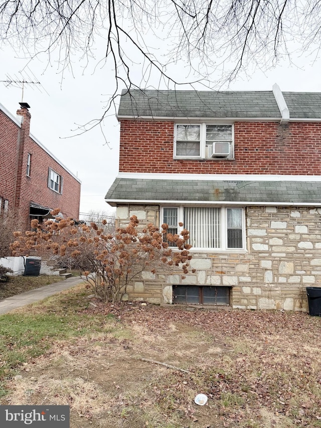 rear view of house featuring central AC