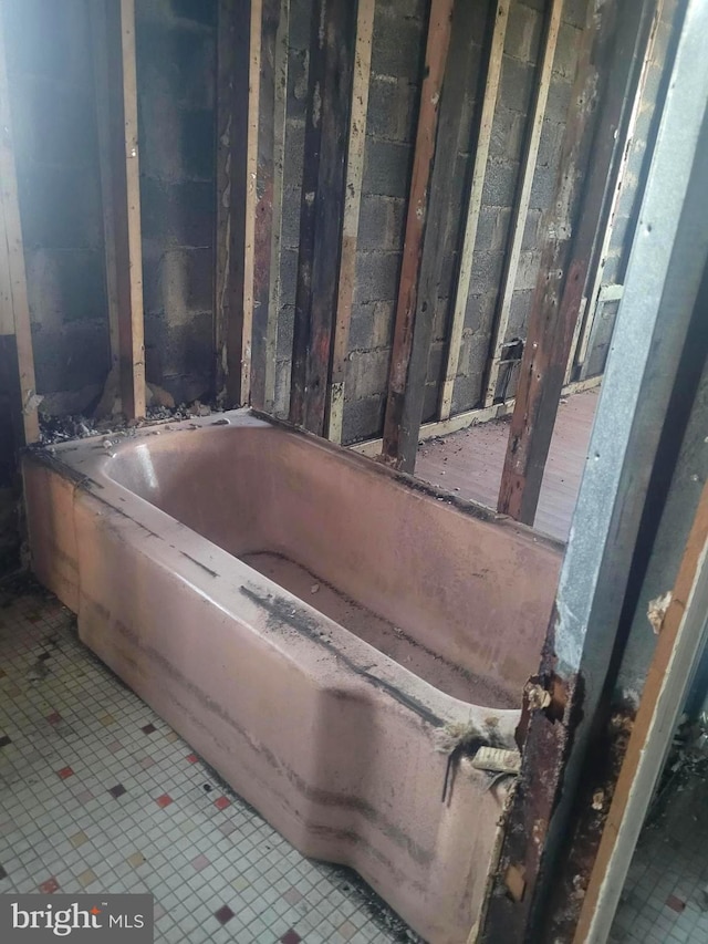 bathroom featuring a tub to relax in and tile patterned flooring