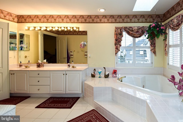 bathroom with a skylight, vanity, and a healthy amount of sunlight