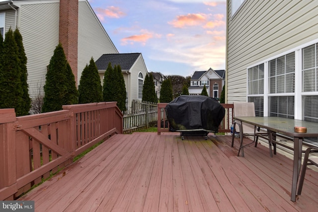 deck at dusk with a grill