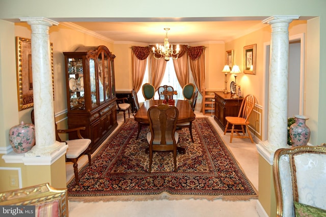 carpeted dining area with a chandelier, decorative columns, and crown molding