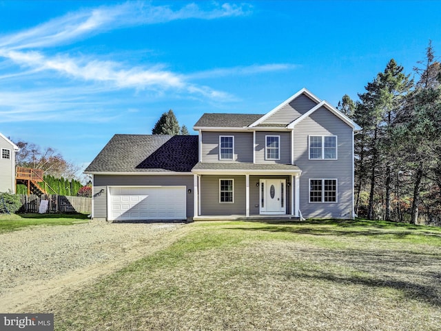 view of front of property with a front lawn, covered porch, and a garage