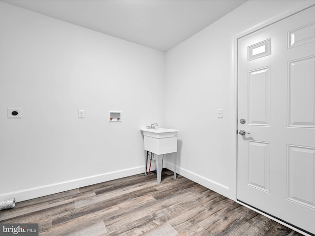 clothes washing area with hardwood / wood-style flooring, washer hookup, and hookup for an electric dryer