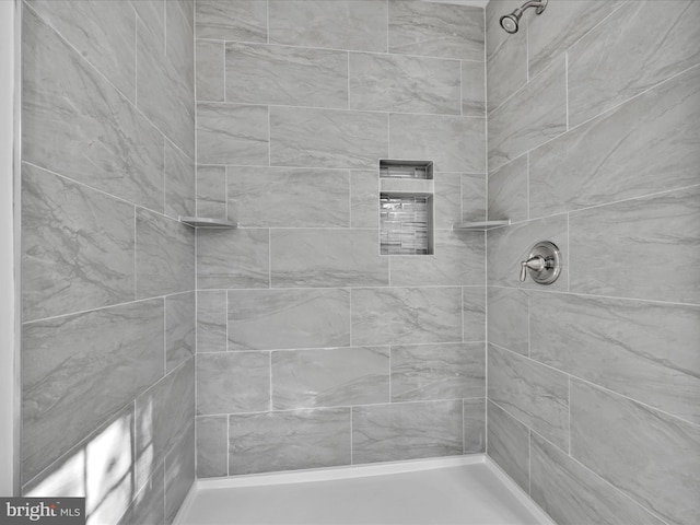 bathroom with tiled shower