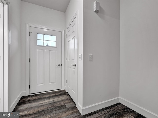 entryway with dark hardwood / wood-style flooring