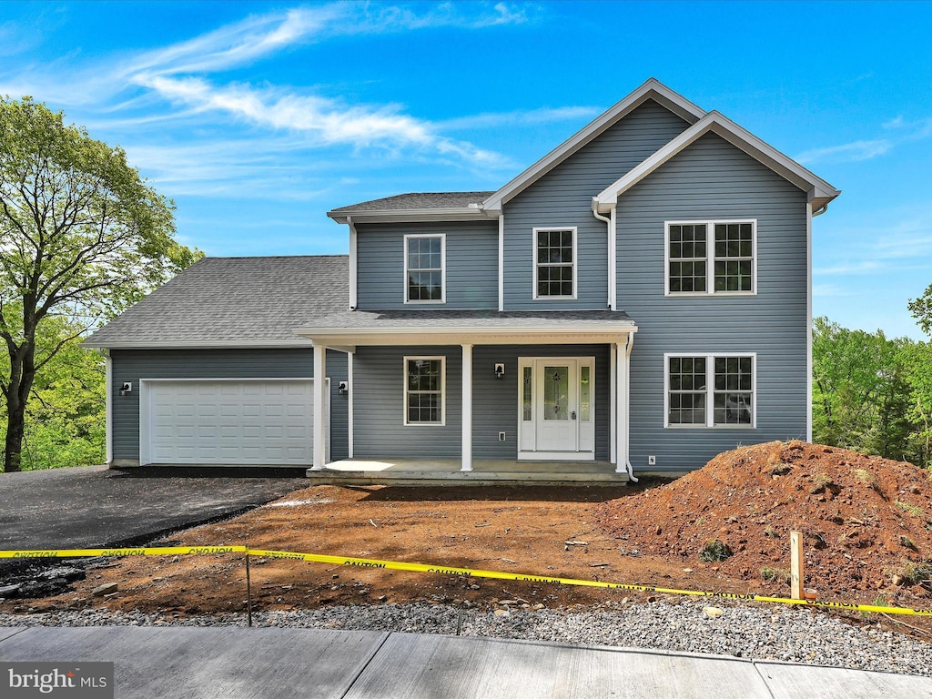 front facade featuring a porch and a garage